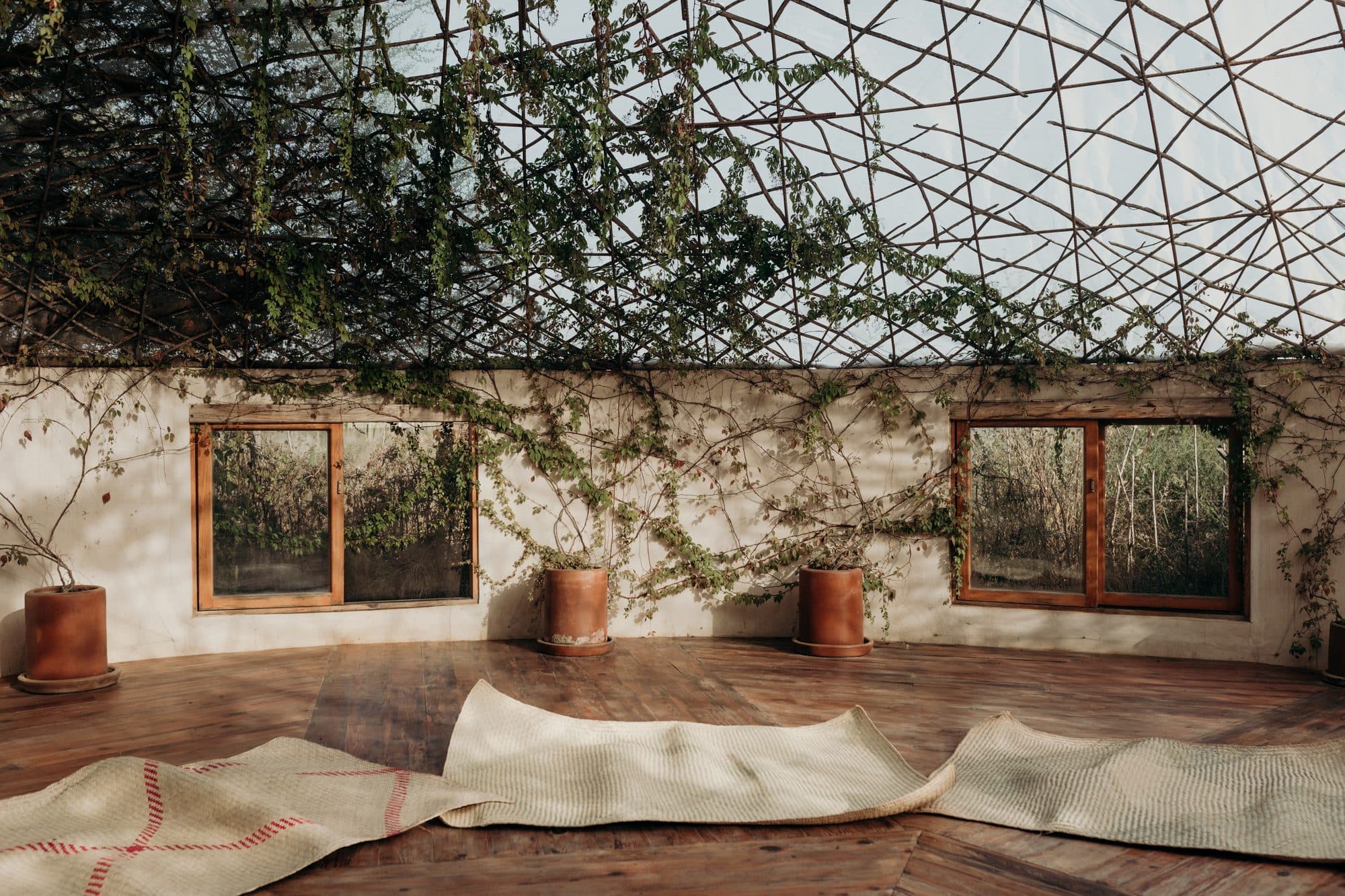 An open yoga and gathering space with cushions on a wooden floor