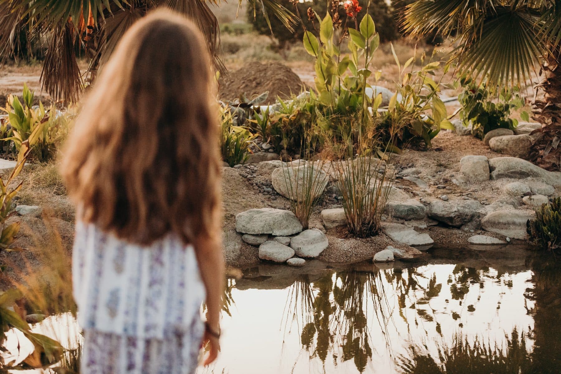 A child exploring the water gardens at Casa Damara