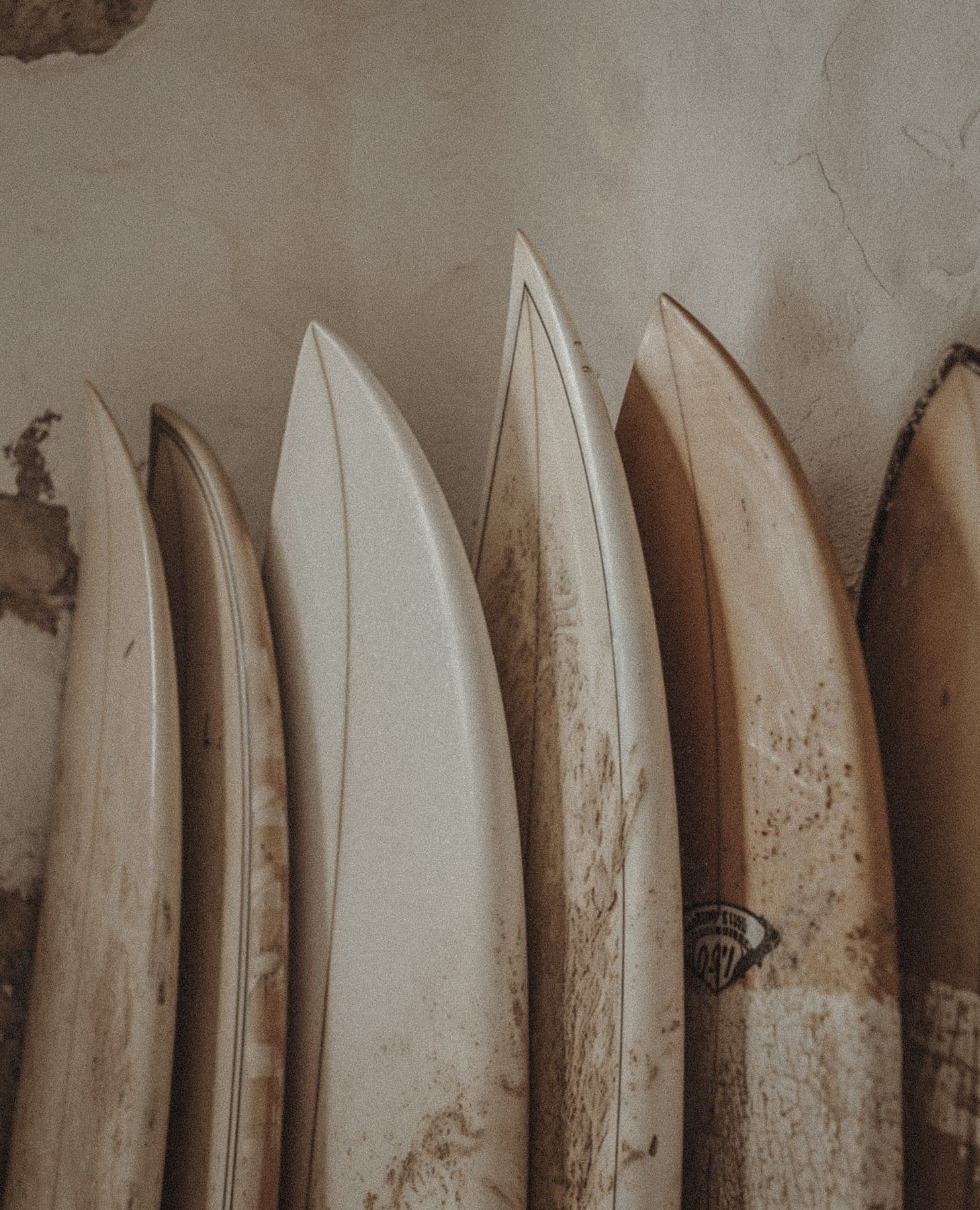 Surfboards lined against an adobe wall at Casa Damara