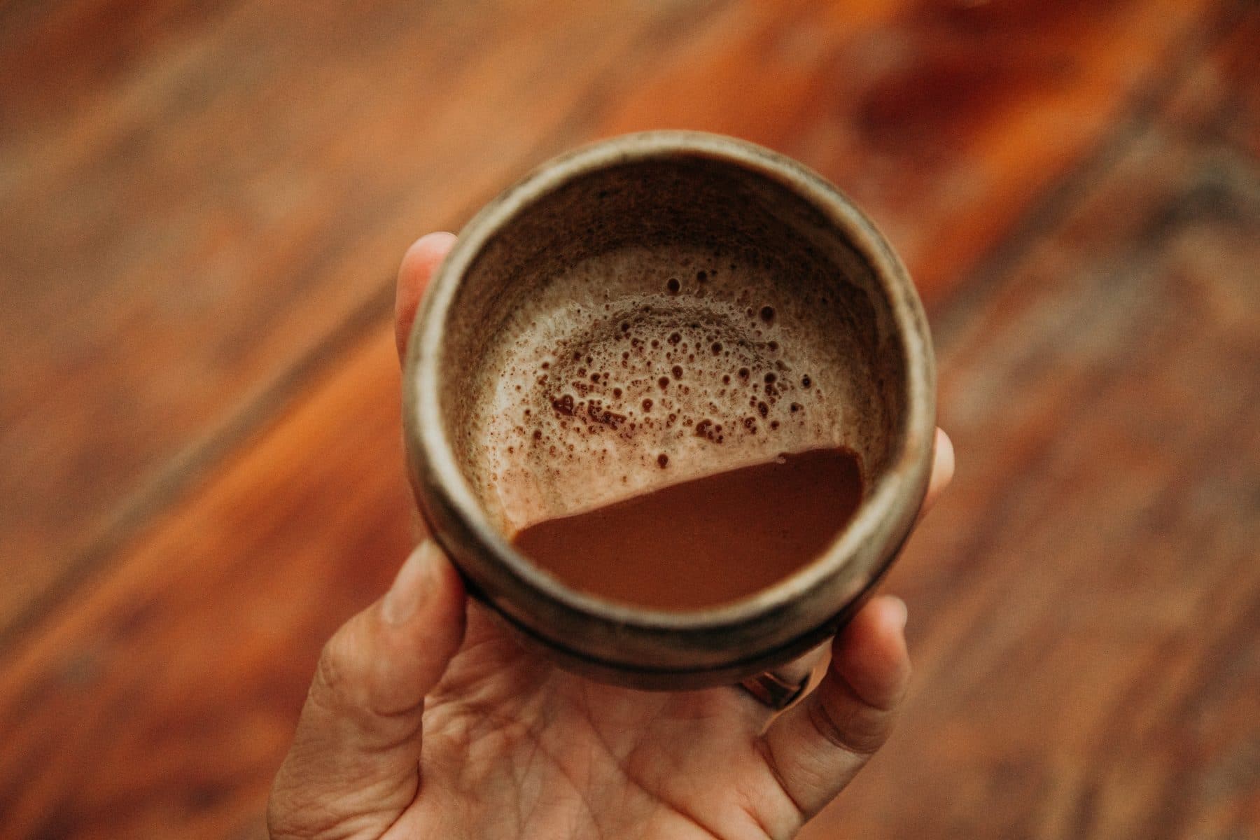 A cacao ceremony cup held in the warmth of gathering